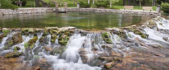 Giant Springs State Park - Rock terraced natural pool with cascading waterfalls in a park setting.